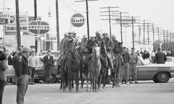 Members of the Dallas County Sheriff's Posse on horseback at the base of the Edmund Pettis Bridge, March 7, 1965